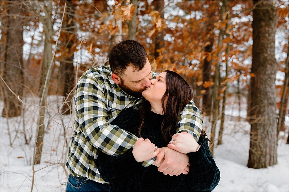 couple-kissing-snow-trees.jpg