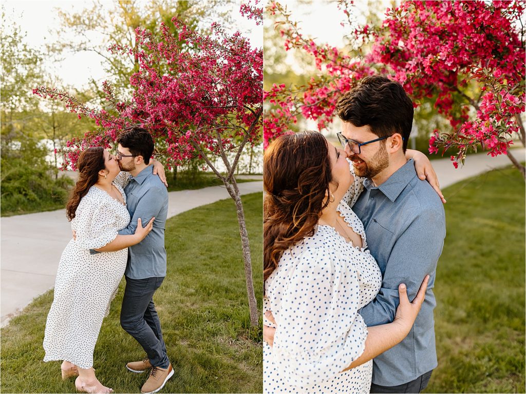 couple kissing by pink flowering tree