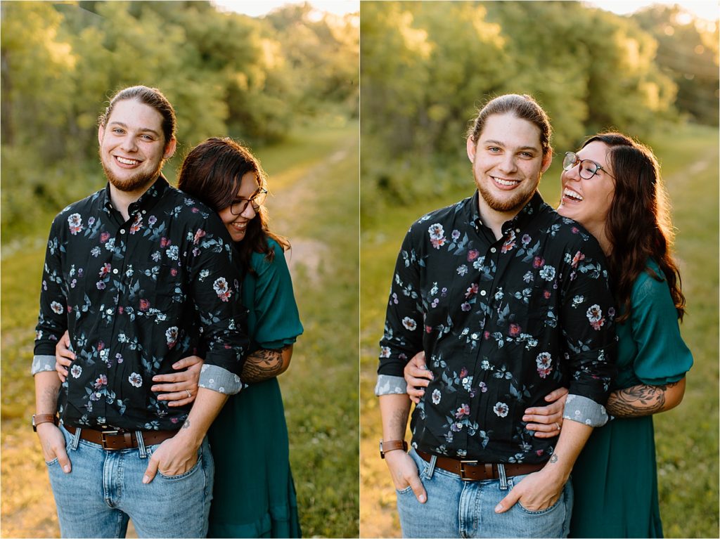 couple smiling at camera in field