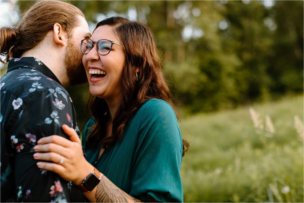 couple laughing in field 