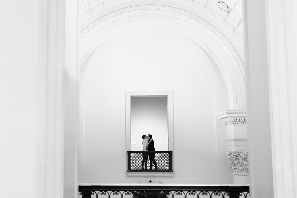 Couple kissing in a doorway at the Minneapolis Institute of Art