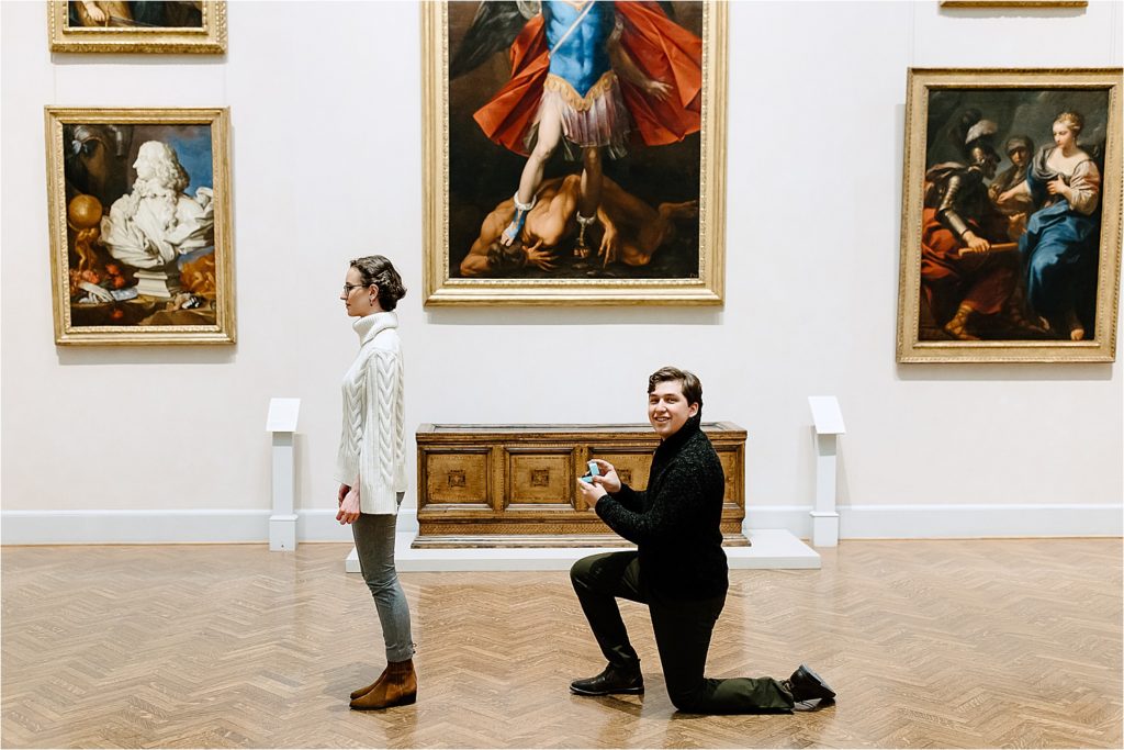 Man on bended knee with engagement ring proposing at Minneapolis Institute of Art